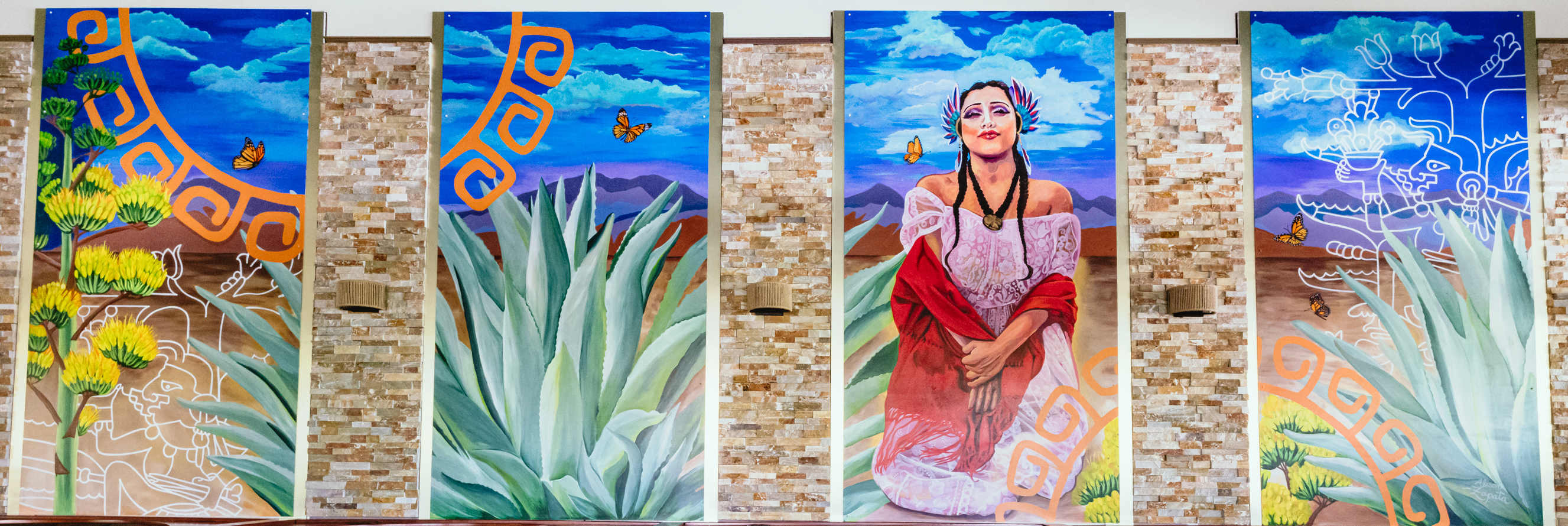 photo of four-frame mural of a woman in a desert landscape
