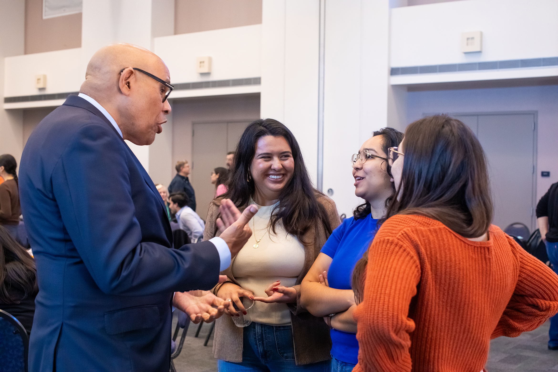 photo of Vice Chancellor for Diversity, Equity, and Inclusion talking with three other people